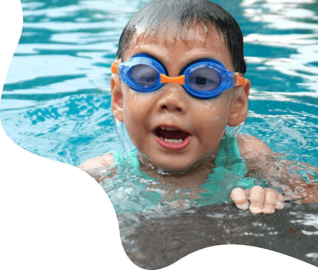 A swim instructor supporting a young swimmer in a pool
